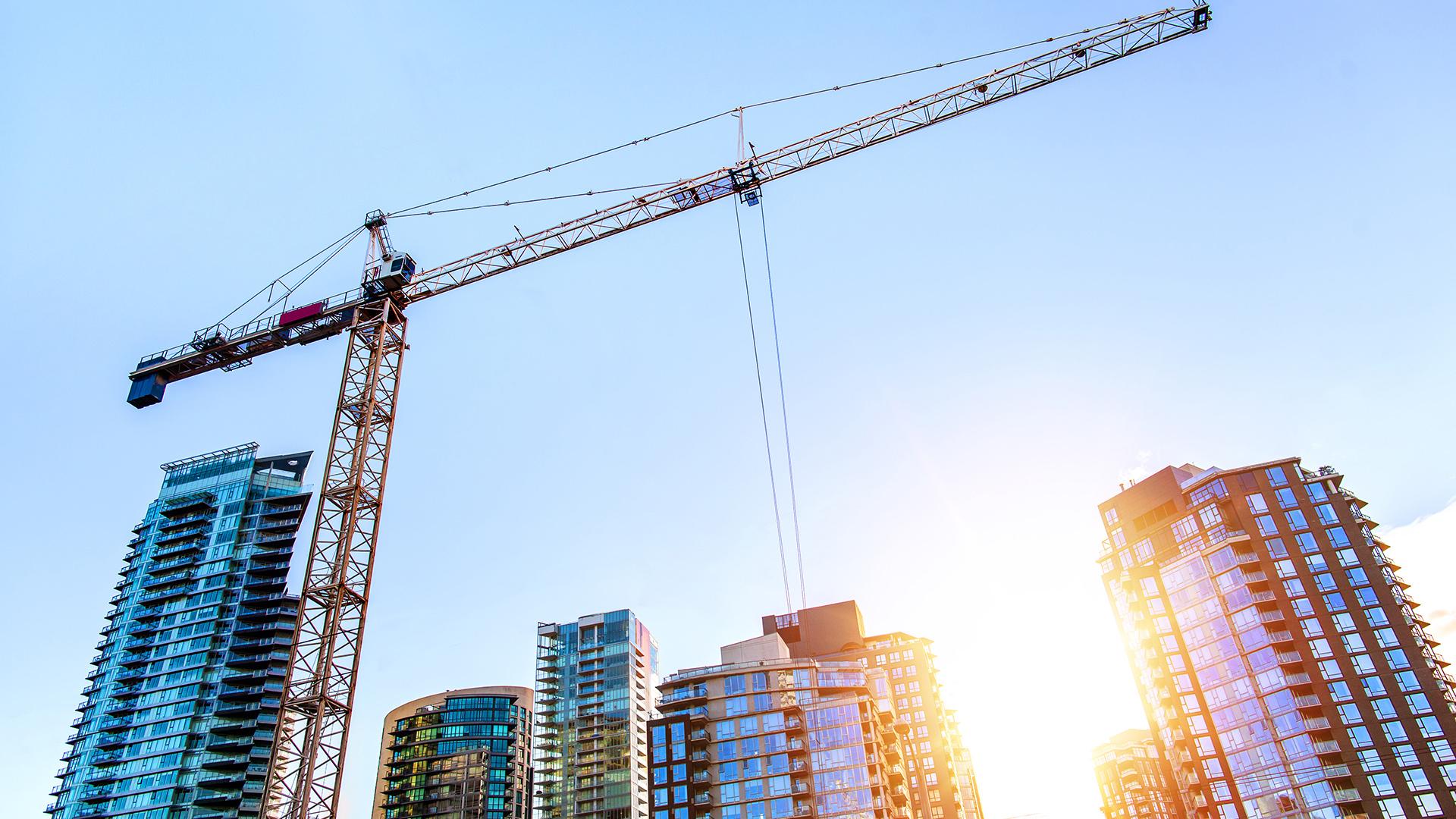 Construction cane amongst high rise building in a major city.