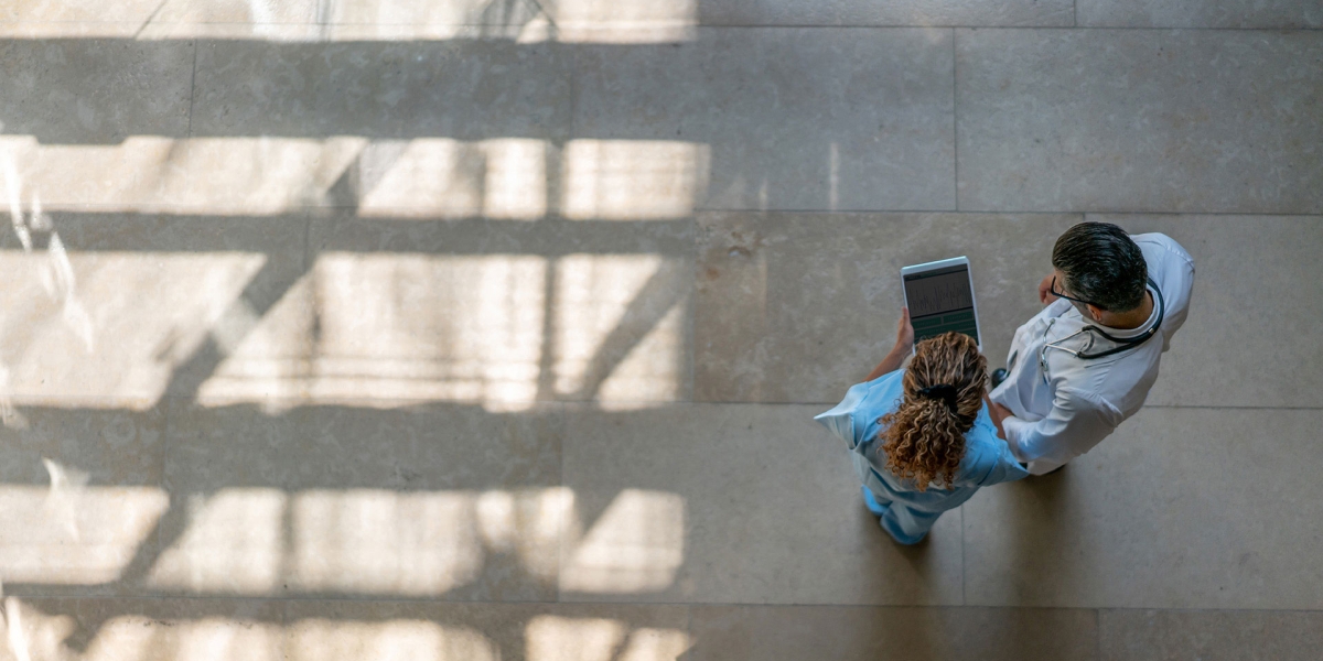 Aerial view of doctor and nurse looking at tablet