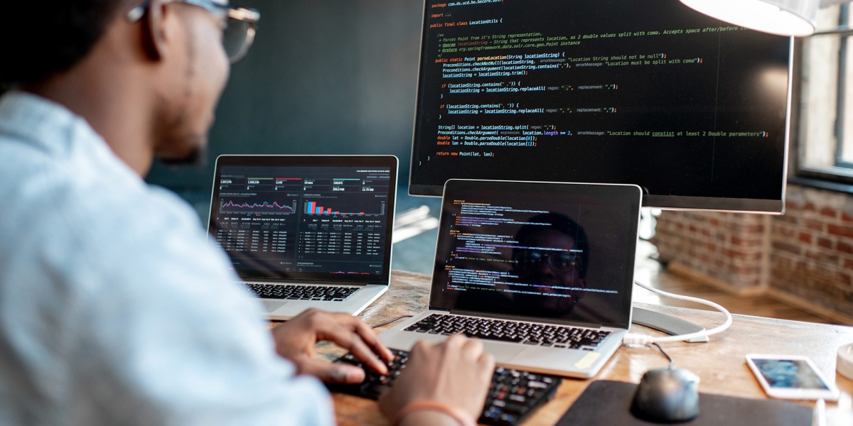 Person working at a desk on code.