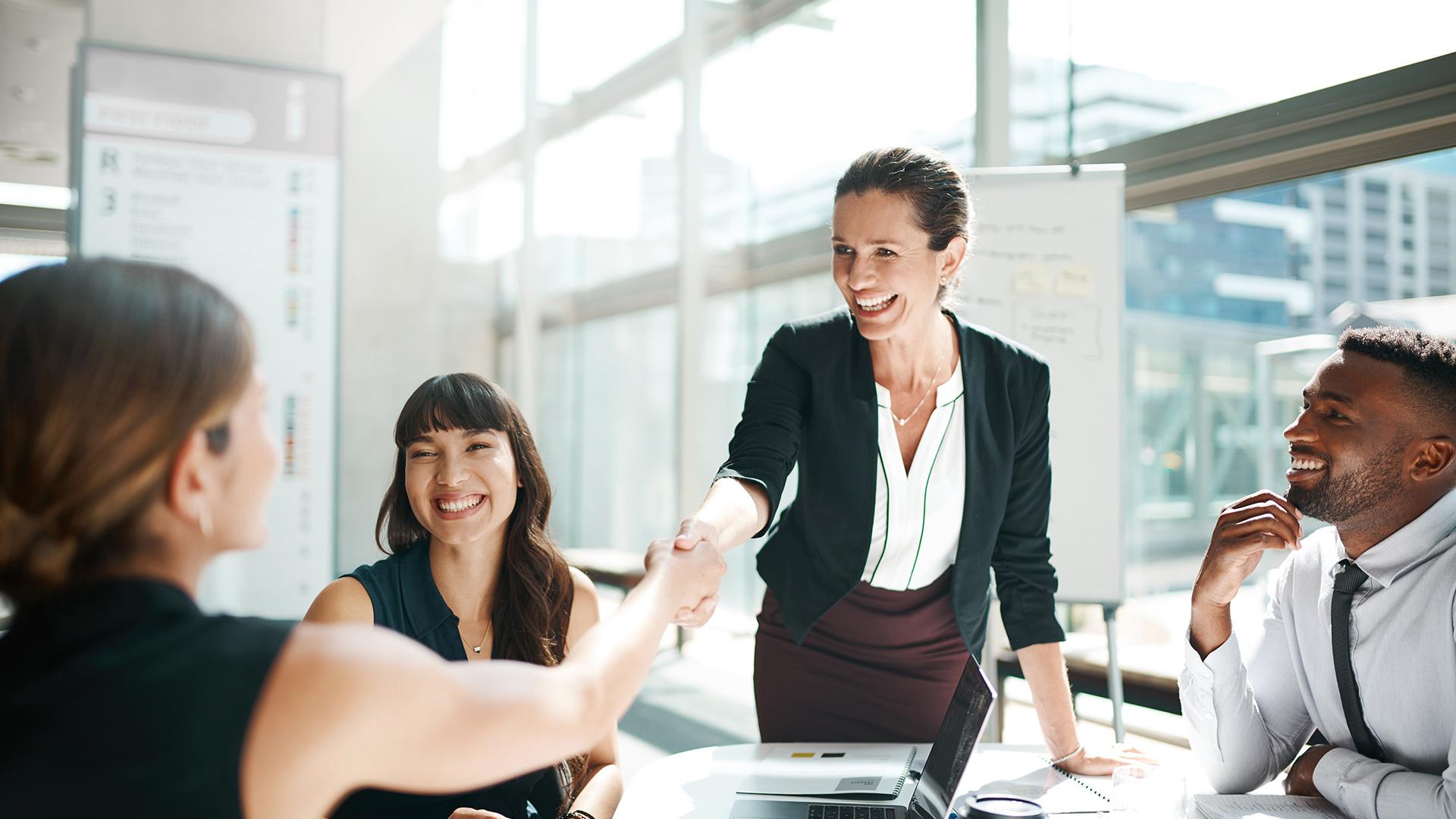 Colleagues shaking hands in a meeting