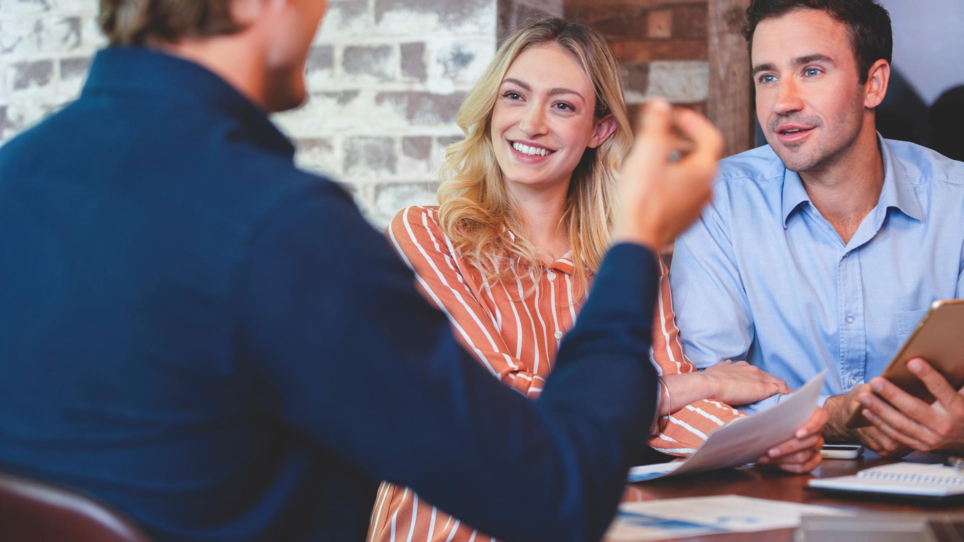A man and woman speaking with a Salesforce advisor.