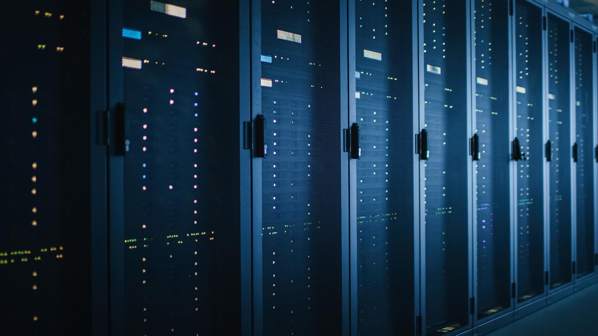 Shot of Dark Data Center With Multiple Rows of Fully Operational Server Racks. 