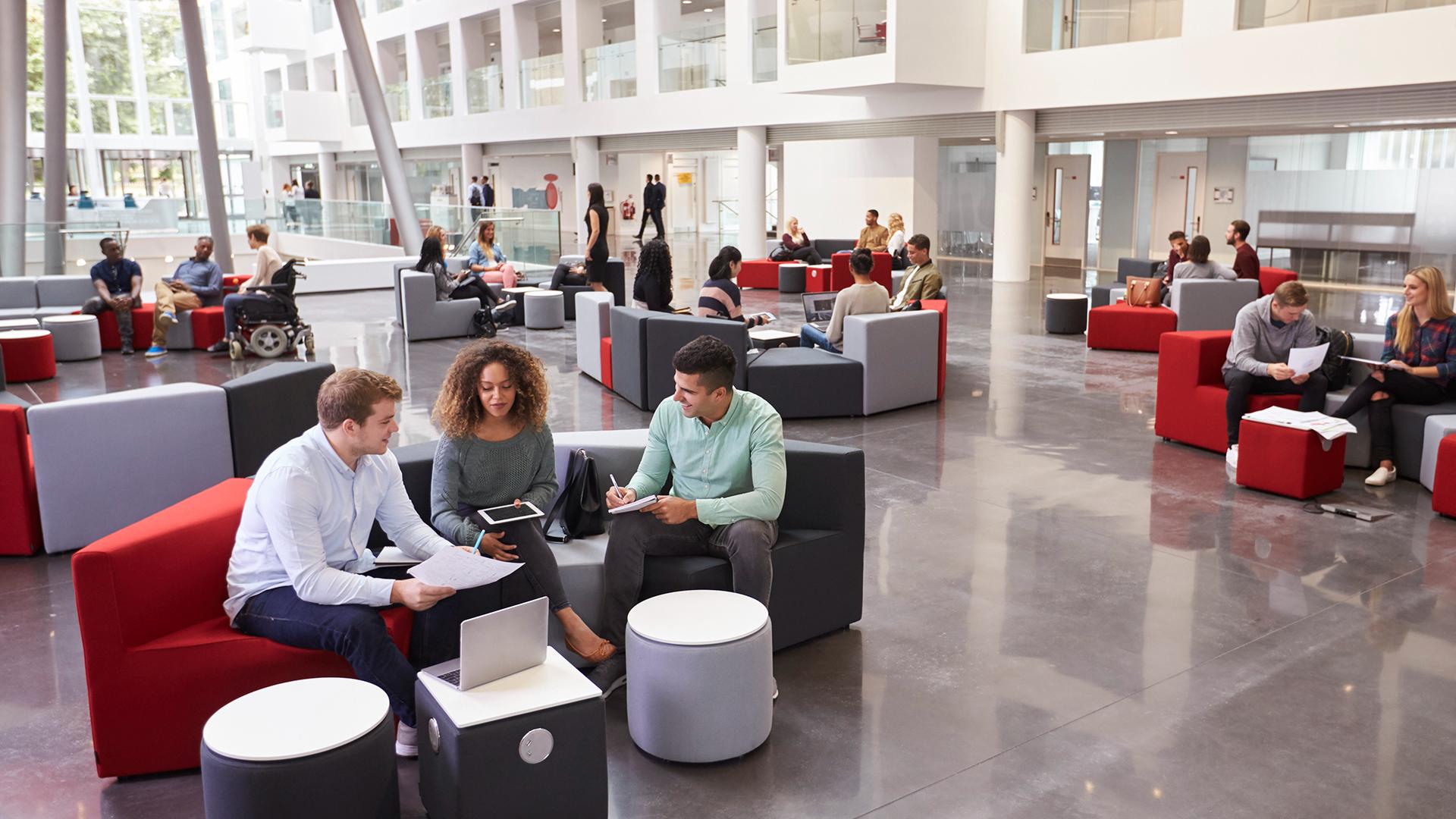 Students sitting in university atrium